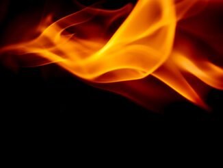 Vibrant orange flames dancing against a dark background, showcasing dynamic movement and intensity.